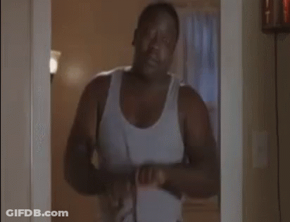 Man In White Tank Top Holding Belt GIF