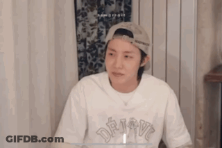 Man In White Tank Top Holding Hair Dryer Talking GIF
