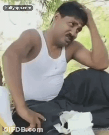 Man In White Tank Top Holding Head GIF