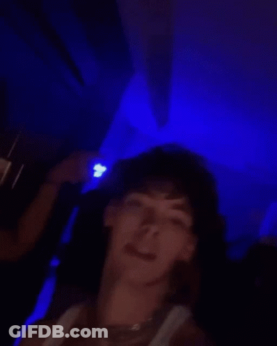 Man In White Tank Top Holding Soda Making Funny Face GIF