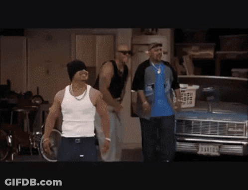 Man In White Tank Top In Front Of Blue Car With License Plate J94107 GIF