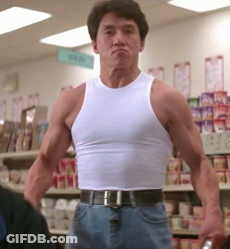 Man In White Tank Top In Front Of Candy Sign GIF