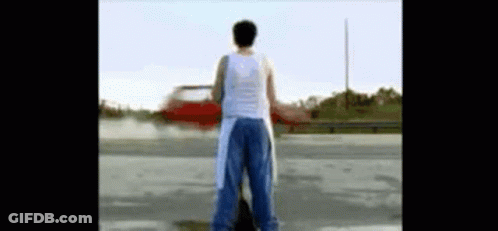 Man In White Tank Top In Parking Lot GIF