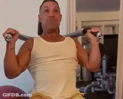 Man In White Tank Top Lifting Barbell Overhead GIF