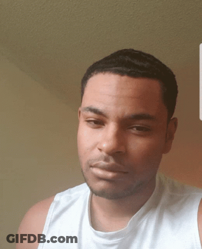 Man In White Tank Top Looking At Camera GIF