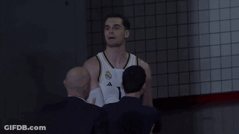 Man In White Tank Top Next To Man In Blue Shirt GIF