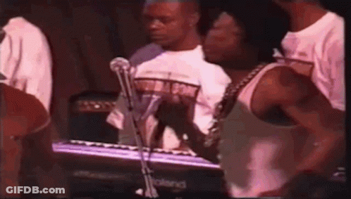 Man In White Tank Top Playing Keyboard For Crowd GIF
