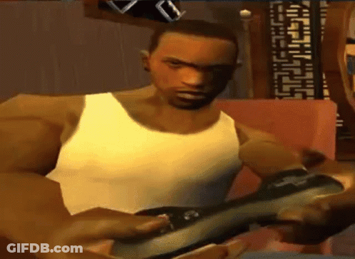 Man In White Tank Top Playing Video Game On Couch GIF