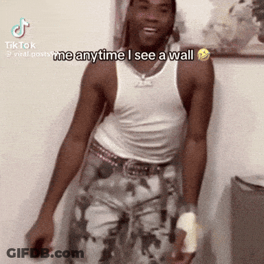 Man In White Tank Top Saying I Mean Anytime I See A Wall GIF