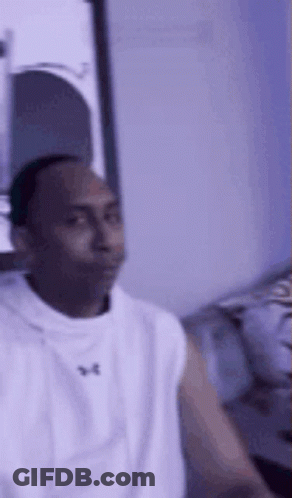 Man In White Tank Top Sitting On Couch GIF