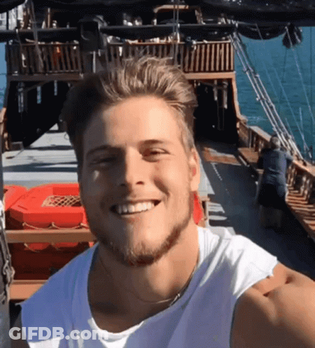 Man In White Tank Top Smiling On Boat GIF