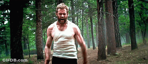 Man In White Tank Top Standing In Forest GIF