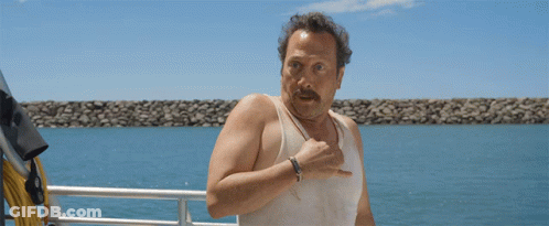 Man In White Tank Top Standing On Boat GIF