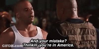 Man In White Tank Top Talking To Another GIF