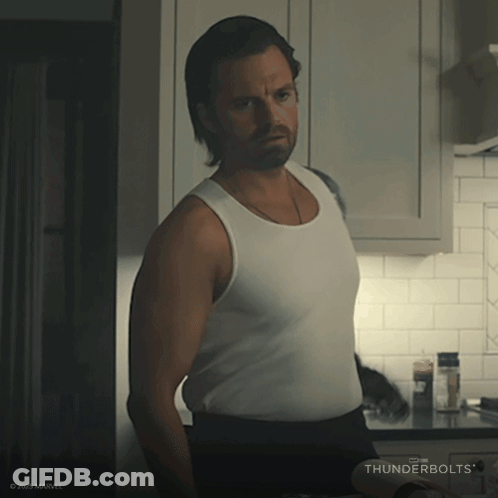 Man In White Tank Top With Thunderbolts In Kitchen GIF