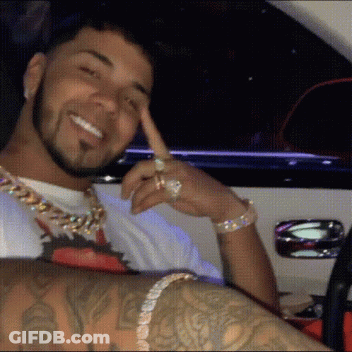 Man In White Turban Holding Flag In Crowd GIF