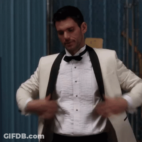 Man In White Tuxedo Adjusting Jacket GIF