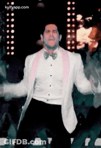 Man In White Tuxedo And Pink Bow Tie Dancing GIF