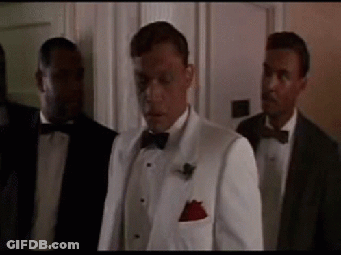 Man In White Tuxedo Next To Two Men In Suits GIF