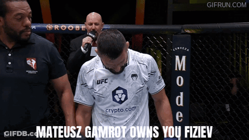Man In White UFC Shirt With Referee GIF