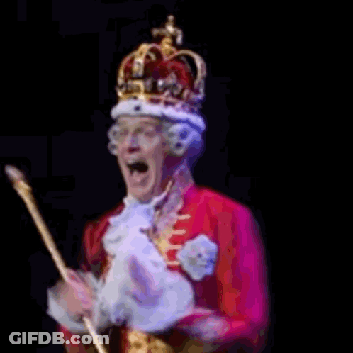 Man In White Vest With Gold Buttons In Dark Room GIF