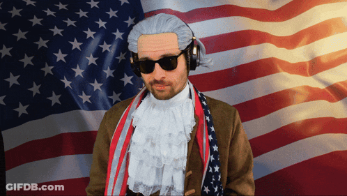 Man In Wig And Headphones Before American Flag GIF