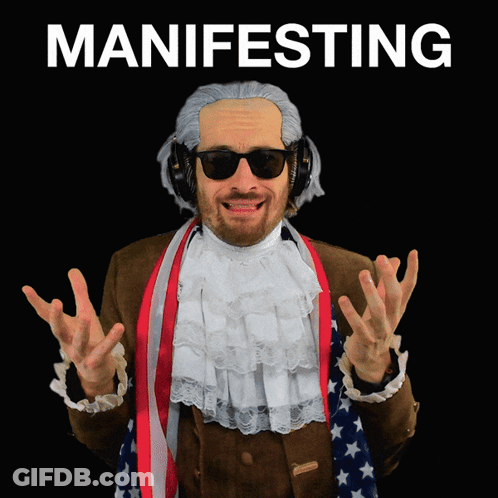 Man In Wig And Headphones Saying Manifesting GIF