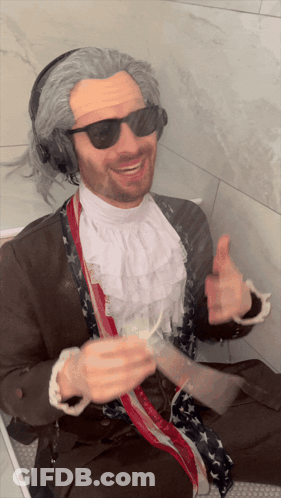 Man In Wig And Headphones Thumbs Up GIF