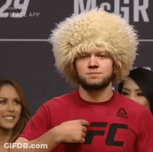 Man In Wig And Red T-Shirt In Front Of Crowd GIF