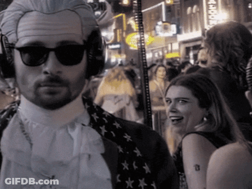 Man In Wig And Sunglasses Before Crowd GIF