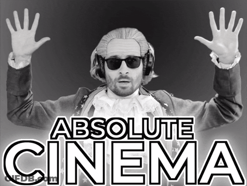 Man In Wig And Sunglasses In Front Of Absolute Cinema Sign GIF
