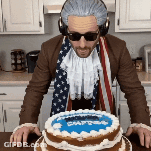 Man In Wig And Sunglasses In Front Of Washington Cake GIF