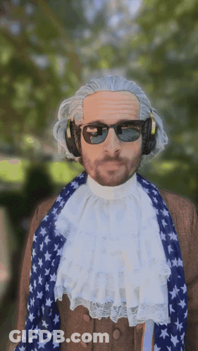 Man In Wig And Sunglasses With American Flag Scarf GIF