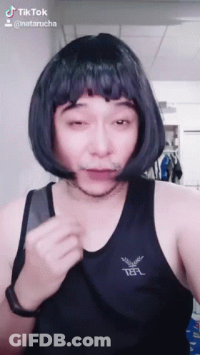 Man In Wig And Telf Tank Top Making Funny Face GIF