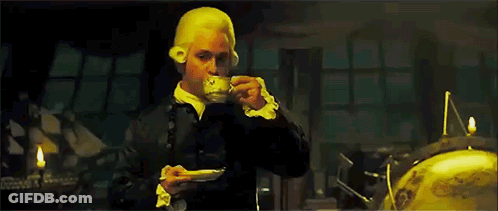 Man In Wig Drinking From Cup GIF