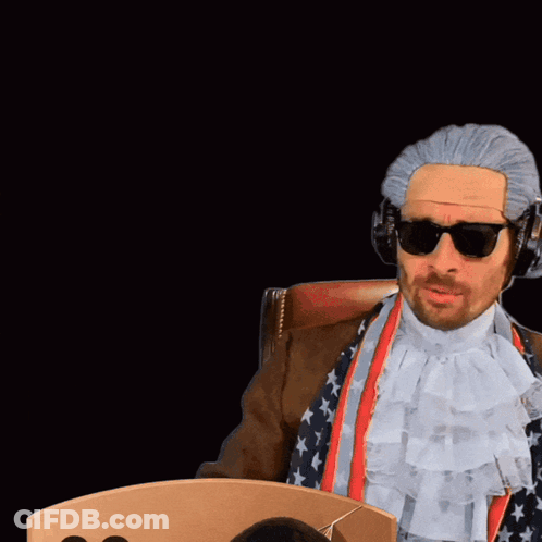 Man In Wig Holding Card With Number 00 GIF