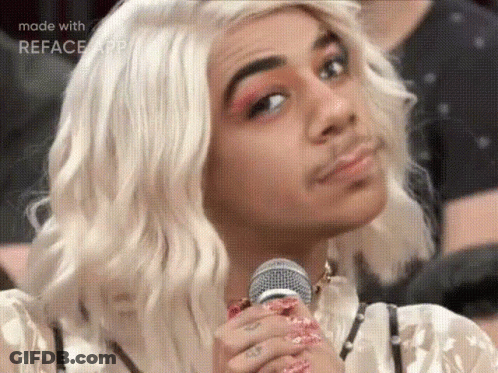Man In Wig Holding Microphone Making Face GIF