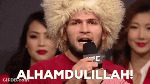 Man In Wig Holding Microphone Says Alhamdulillah GIF