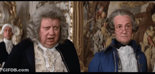 Man In Wig Next To Man In Blue Coat GIF