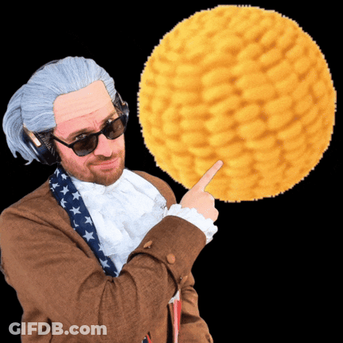 Man In Wig Pointing At Yellow Ball GIF