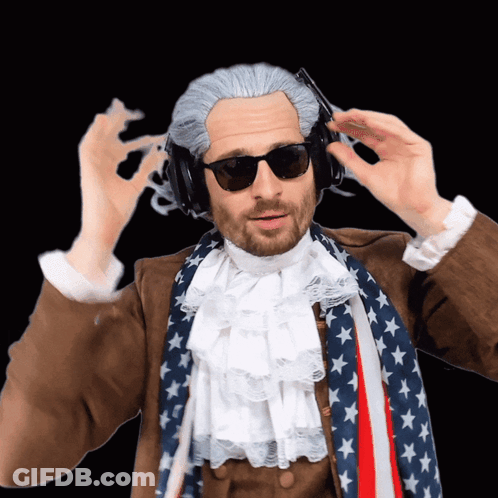 Man In Wig, Sunglasses, Headphones, American Flag Scarf GIF