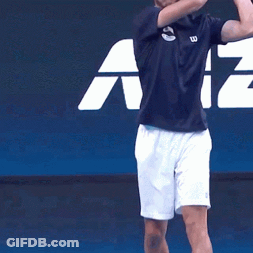 Man In Wilson Shirt And White Shorts Playing Tennis GIF