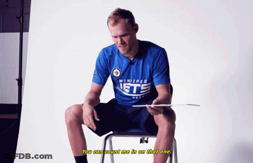 Man In Winnipeg Jets Shirt Sitting On Chair GIF