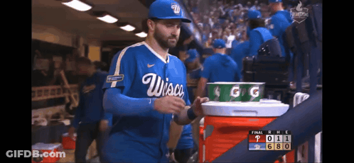 Man In Wisconsin Baseball Uniform Holding Cooler GIF