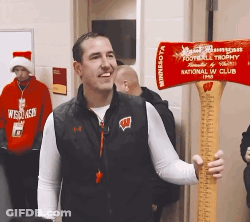 Man In Wisconsin Vest Holding Axe GIF