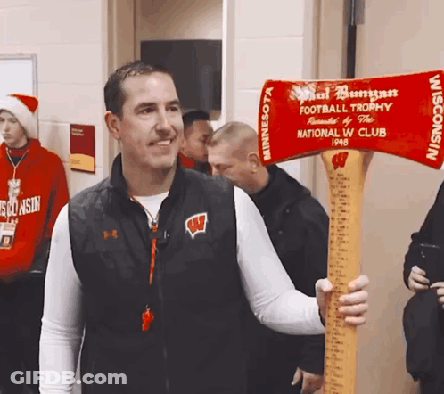Man In Wisconsin Vest Holding Football Trophy GIF