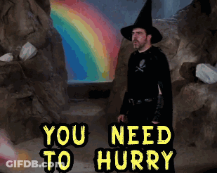 Man In Witch Costume Standing In Front Of Rainbow Saying You Need To Hurry GIF