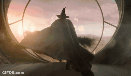 Man In Witch Hat In Front Of Large Window GIF