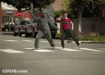 Man In Wolf Costume Crossing Street GIF