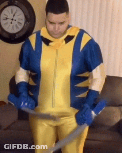Man In Wolverine Costume Holding Vacuum Cleaner GIF